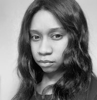 a black and white photo of a woman with long hair